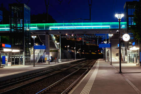 Front view train station in Switzerland at night with no people. Illuminate the scene of modern street lamps. None insideの写真素材