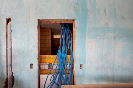 Interior of an ancient villa undergoing renovation with blue painted walls and electrical pipes...