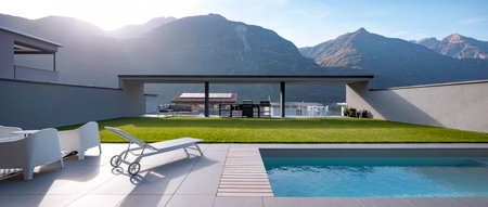 Panoramic view garden with pool of modern villa. There is a sitting area with armchairs, a deck chair, and at the back is the barbecue. In the background there are mountains. Banner, nobody insideの写真素材