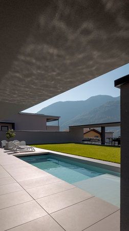Modern house detail with swimming pool and garden. Reflection of water on the ceiling. Nobody insideの写真素材