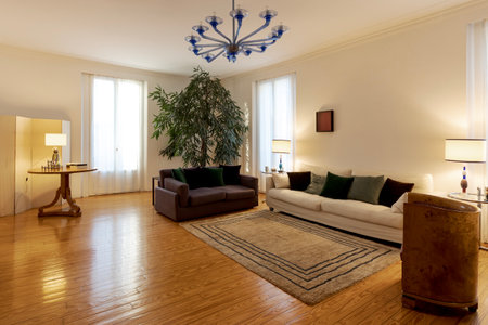 Elegant living room with large sofas and armchair. Vintage apartment interior with modern furniture. Nobody insideの写真素材