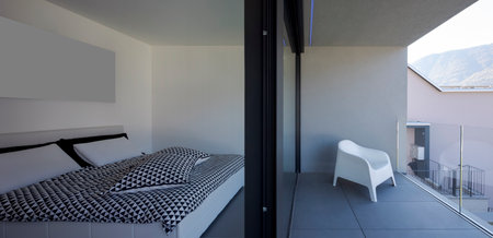 Front view bedroom with open window and terrace on white armchair. Nobody insideの写真素材