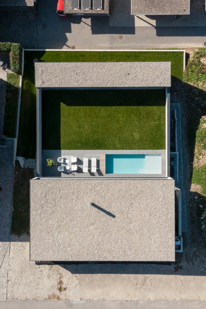 Exterior modern villa with swimming pool. The house is surrounded by mountains. Nobody insideの写真素材