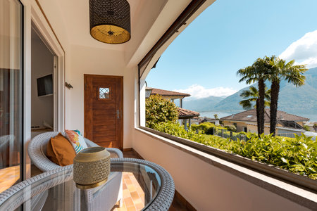 Terrace overlooking nature, mountains and lake in Switzerland. Sunny spring day. Nobody inside.の写真素材