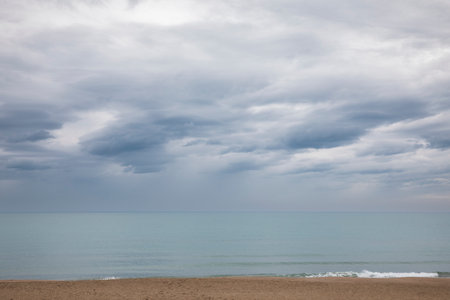 Italian maritime landscape on a gray spring day. Very cloudy sky. Nobody insideの写真素材