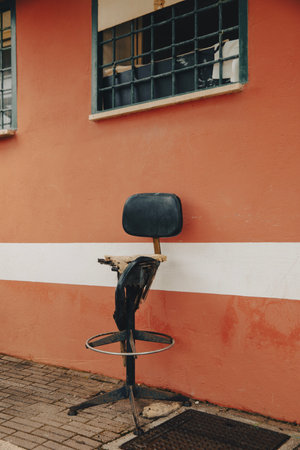 Detail of a destroyed and abandoned black leather chair. Nobody insideの写真素材