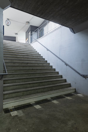Stairs of a concrete railway station in Switzerland leading to the pedestrian underpass. No one insideの写真素材