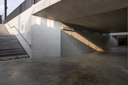 There is a stairway with a long pedestrian underpass at the station. Modern design with no one insideの写真素材