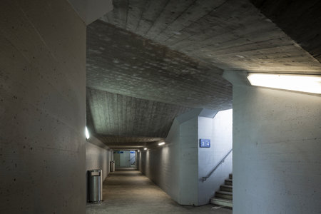 Long concrete pedestrian corridor under the train station with the staircase. No one insideの写真素材