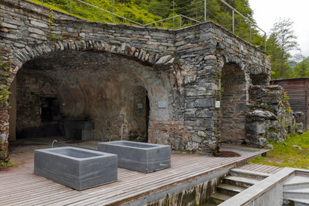 Thermal baths with a view of the river and Swiss nature. Behind it is a cave. No one inside.の写真素材