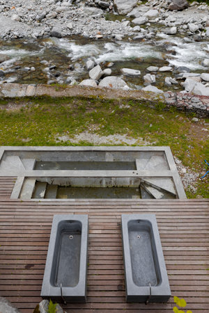 Top view of the thermal baths on a wooden platform overlooking the river and Swiss nature. No one inside.の写真素材