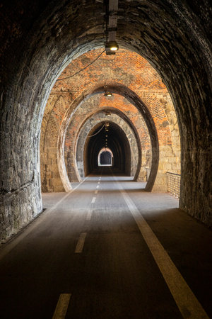 Cycle path in Liguria built on the old train route. Tunnel made from red bricks. Nobody insideの写真素材