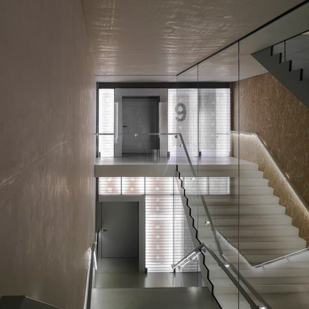 Space with stairs in an old but renovated building with large windows. Nobody aroundの写真素材