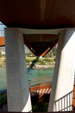 Detail of the pylons of a rusty modern bridge, under which the river Ticino flows. Sunny summer day. No one insideの写真素材