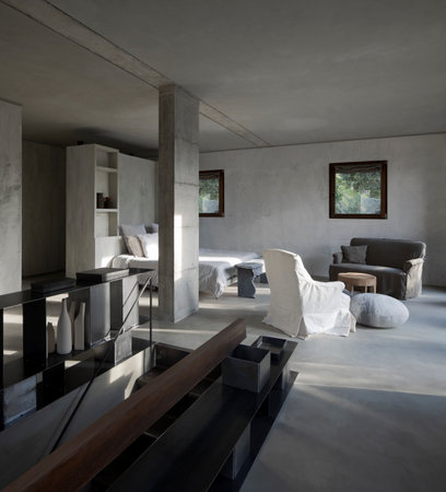 Modern bedroom of a designer farmhouse with a double bed with lots of pillows and large windows that let in lots of natural light. No one insideの写真素材