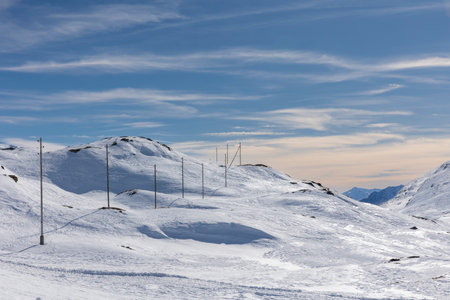 Spectacular landscape of the Bernina Pass in Switzerland on a winter day with lots of sunshine. All the mountains are covered with a lot of snow. Nobody insideの写真素材