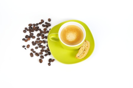 green espresso cup in the center, a crostini and coffee beans