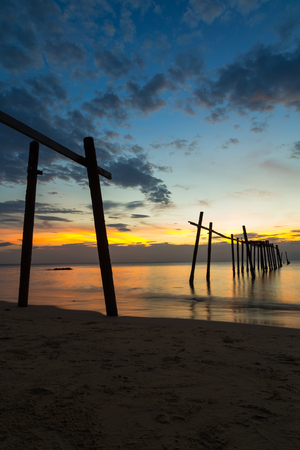 The wooden bridge is broken on the beach at sunset time, Phang-nga Thailandの写真素材