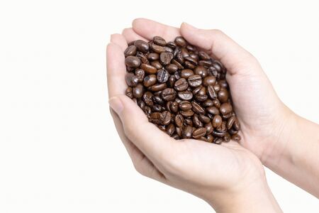 Coffee beans - Close up of person holding coffee beans in hands.の写真素材