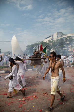 group of men march in the middle of firecrackers and smoke at a vegetarian festival, Phuket, Thailand, on October 5, 2019.のeditorial素材