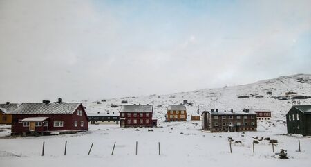 coulourful houses in the snowy hill of Norwayの写真素材