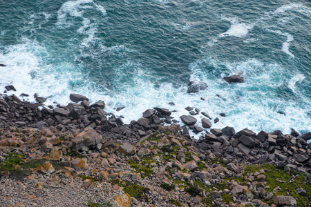Rocky beach with white sea foam