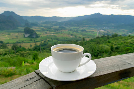 Morning cup of coffee with mountain backgroundの写真素材