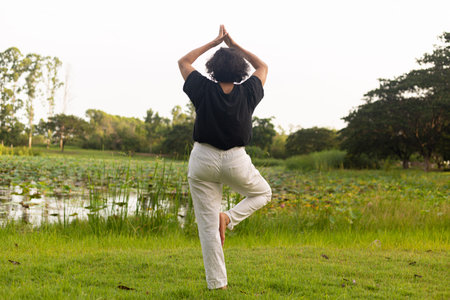 woman doing exercises on green nature.