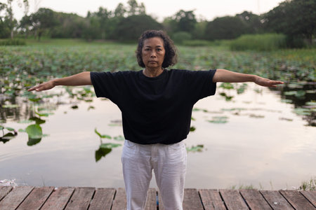 woman doing exercises on green nature.