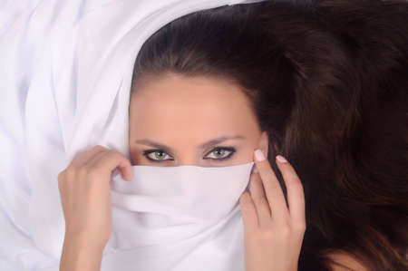 Voluptuous look of gorgeous young woman. On a white backgroundの写真素材