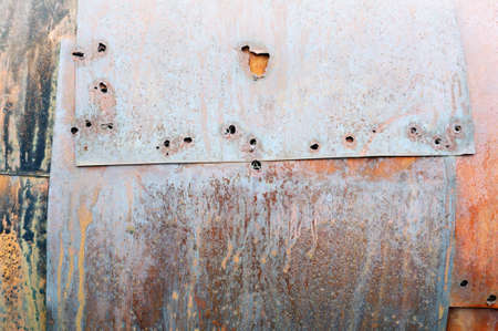Rusty metal surface with holesの写真素材