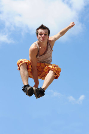 young guy does the big jump in air