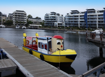 Colorful boats in Cape Town, South Africa  - Cute boat moored to a wharf  Cape Town is the most populated city in South Africa のeditorial素材