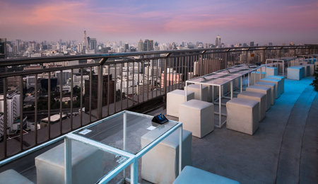 Table   chairs at terrace, urban city skyline, Bangkok, Thailand   - Bangkok is the capital city of Thailand and the most populous city in the country の写真素材