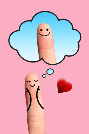 A happy couple in love, valentine concept  - Happy finger, Girl in love blushing with hands in cheeks thinking on the boy of her dreams の写真素材