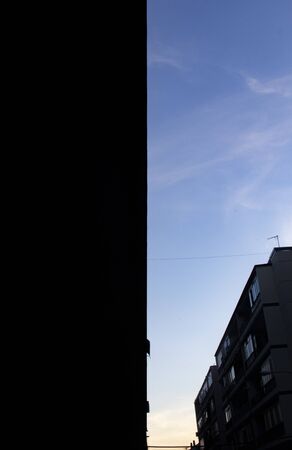 Building silhouete drawing a perfect stright line on a blue lineの写真素材