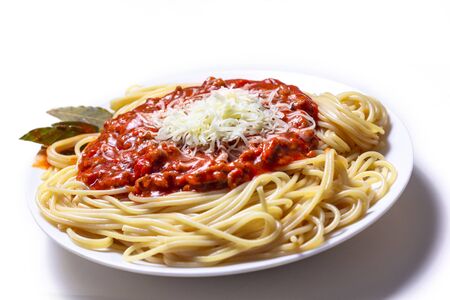 Delicious Spaguetti Pasta with bolognesa tomato sauce and chopped meat. Adorned with cheese and Laurel leafの写真素材