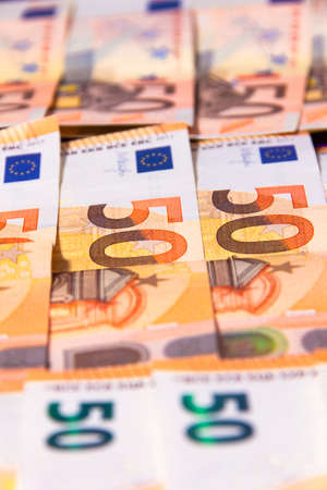 stacked up 50 euros Bills with coinsの写真素材
