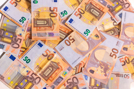 stacked up 50 euros Bills with coins