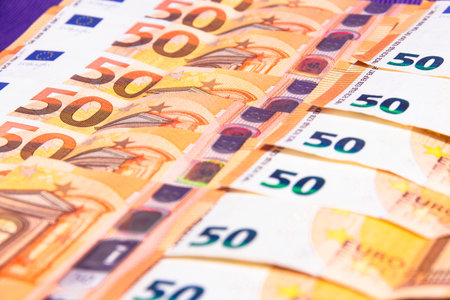 stacked up 50 euros Bills with coins