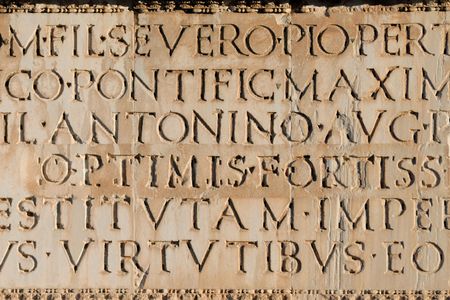 Close up of ancient Roman Latin Inscription in stone background.の写真素材