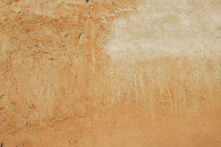 textured ochre colored wall in rome with subtle markingsの写真素材