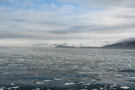 Svalbard, Norway 06.20.2018: The north Pole -Arctic Landscaper with Ice, Iceberg, Mountains in a clear blue ocean and skyの写真素材