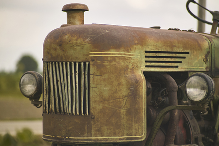 Detail of Old vintage tractor worn and with signs of time in a field ready for another hard day's workの写真素材
