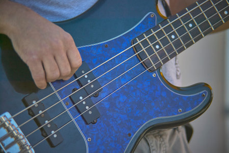 Detail of a Guitarist who plays his electric guitar at a live rock music concert.