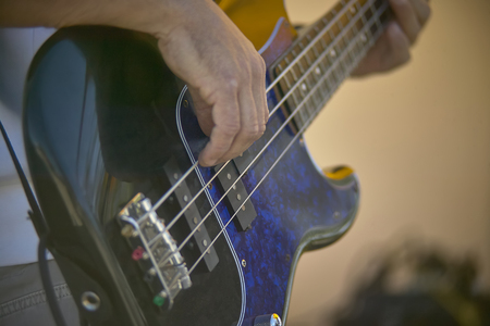 Detail of a Guitarist who plays his electric guitar at a live rock music concert.の写真素材