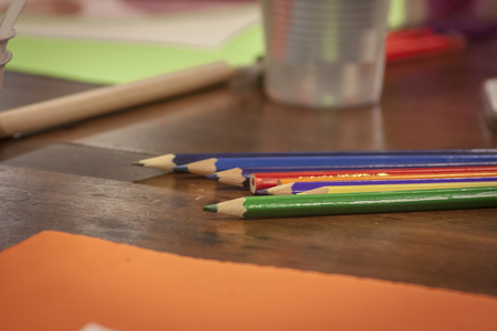 Colorful wooden pencils leaning over a drawing board in a classroom of a design school.の写真素材