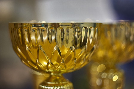 A trophy or golden cup used as a prize for a sports competition.の写真素材