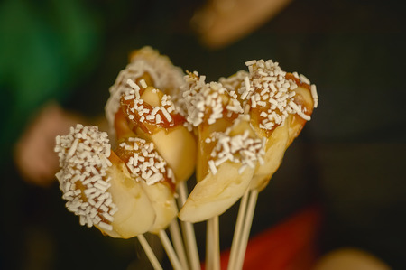 Slices of candy apples covered with sugar granules.の写真素材
