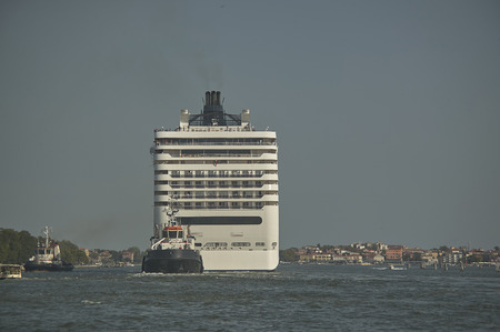 Large cruise ship while sailing close to the coast of Venice, the only city in the world. The problem of big ships in Venice.の写真素材